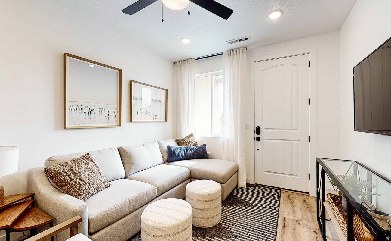 Living area featuring wood-finish flooring, recessed lighting, and a ceiling fan