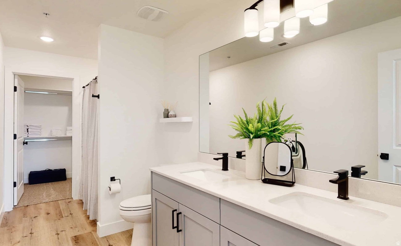 Double vanity with light gray cabinetry and white countertops