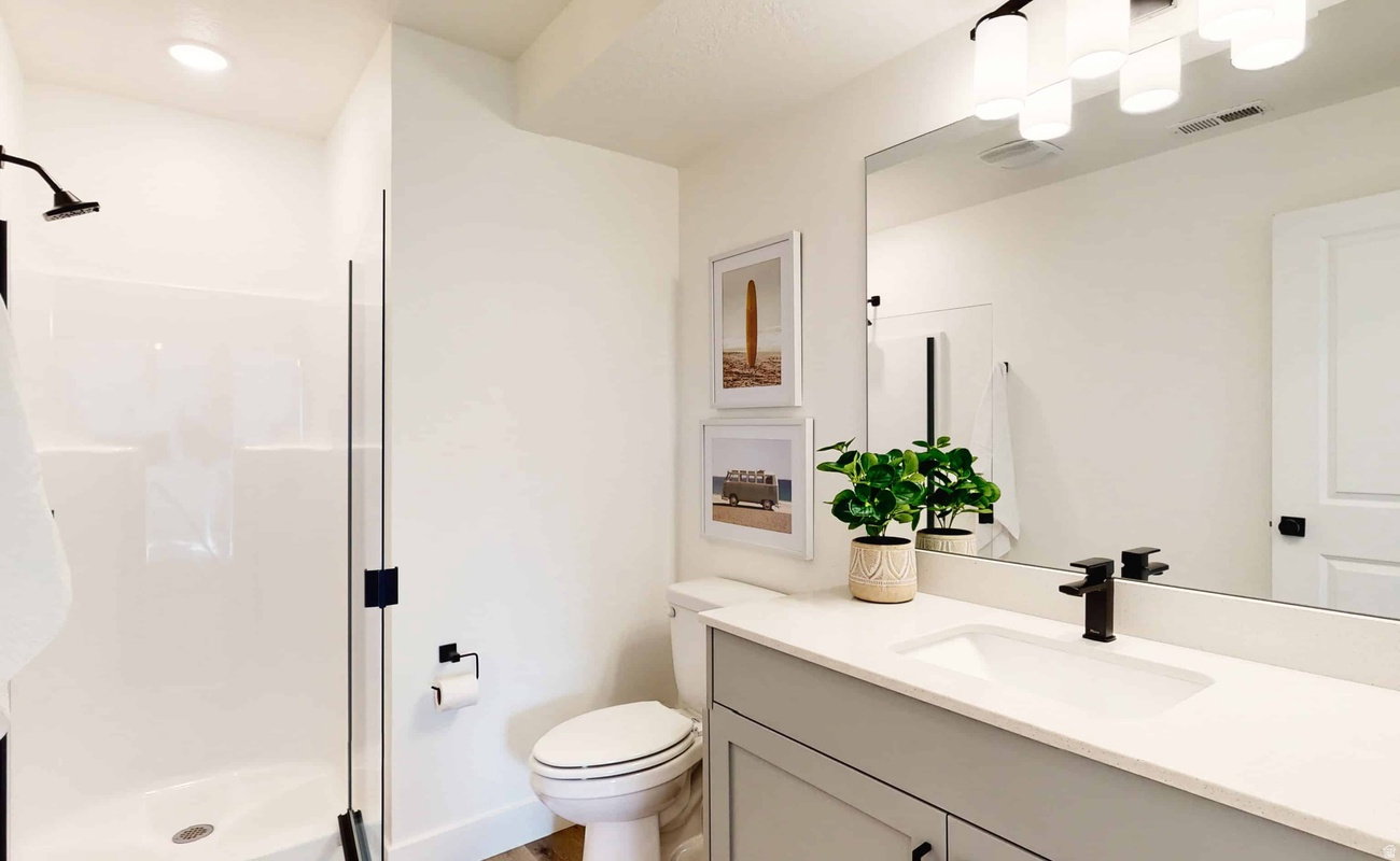 Bathroom featuring a light gray vanity with a white countertop and integrated sink