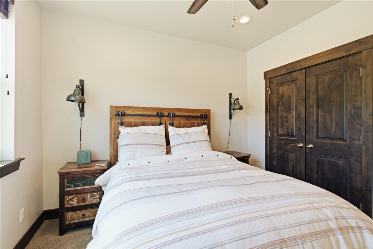 Room featuring a ceiling fan, recessed lighting, wood-finish flooring, and a window with dark wood trim