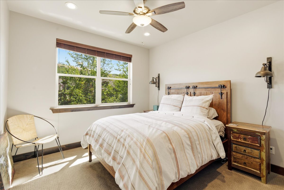Carpeted room with a large window, recessed lighting, and a ceiling fan