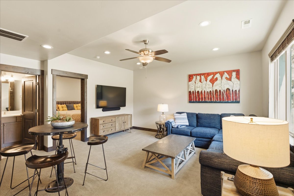 Spacious living area featuring neutral carpeting and recessed lighting