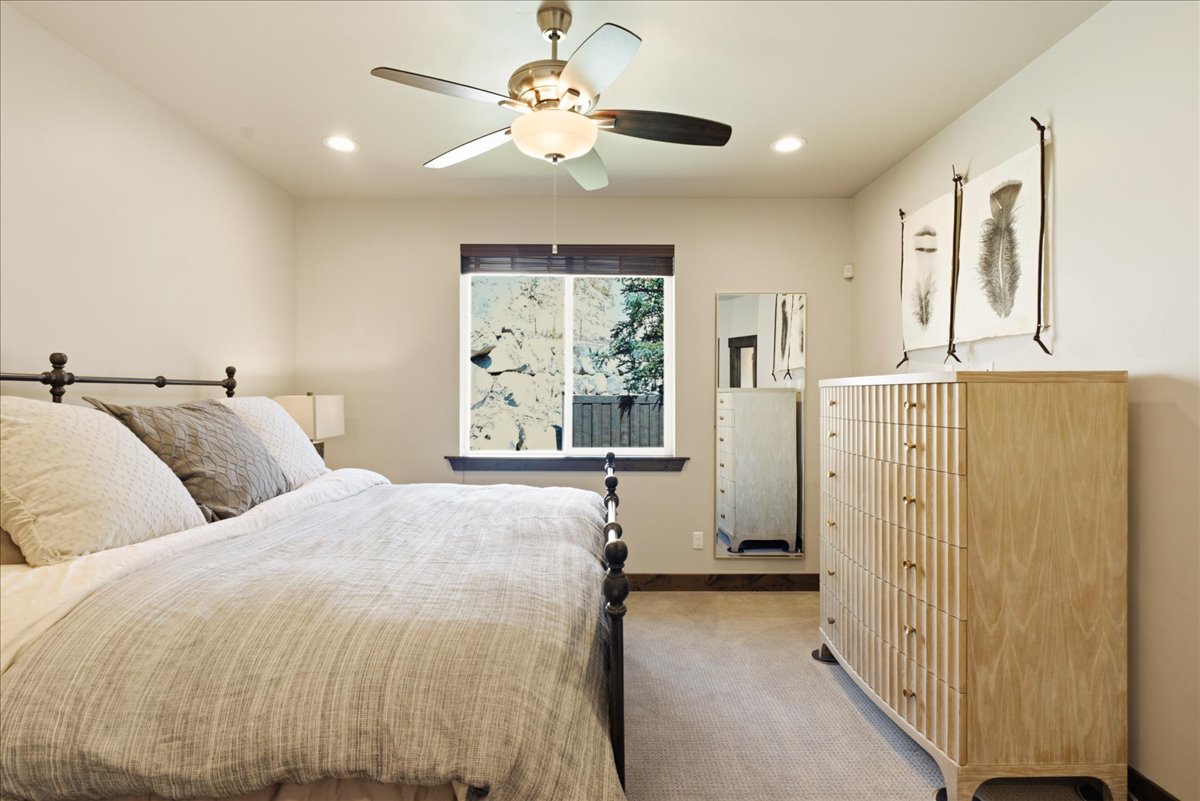 Neutral tone walls with recessed lighting and a ceiling fan