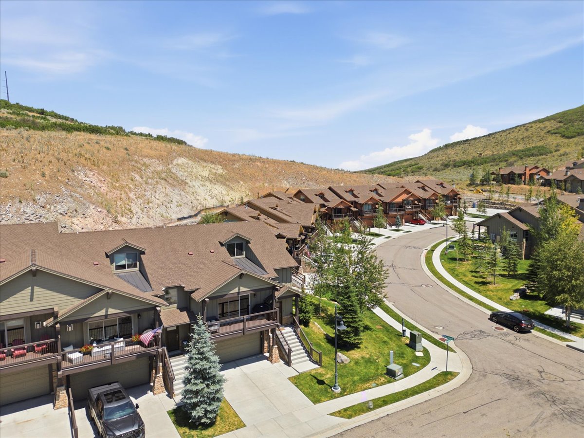 Townhome exterior featuring dormer windows and attached garages