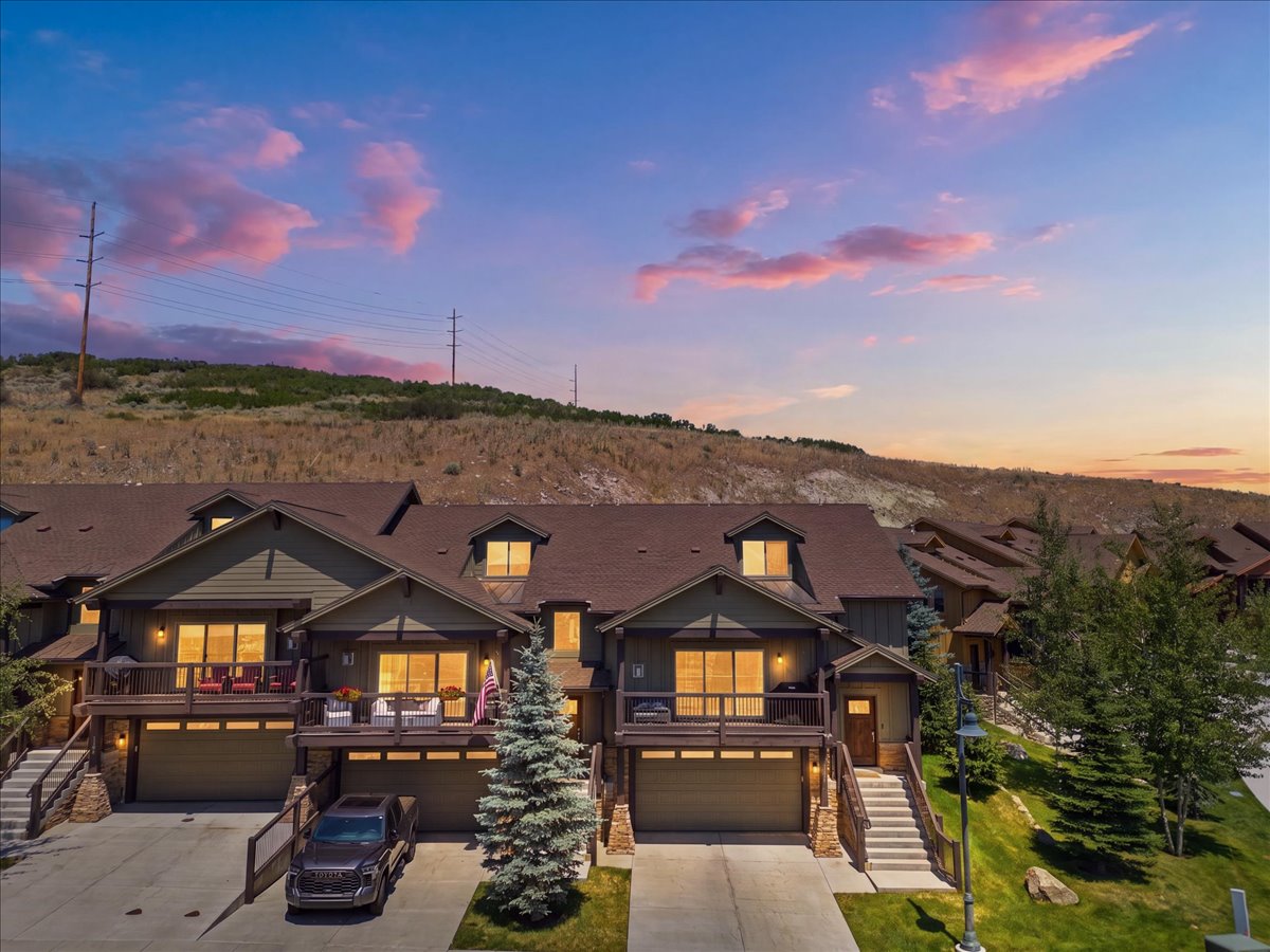 Townhome exterior featuring earth-toned siding and stone accents