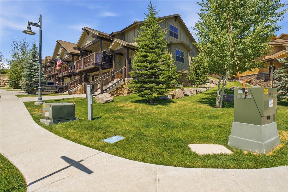 Multi-level property featuring board-and-batten siding with stone accents