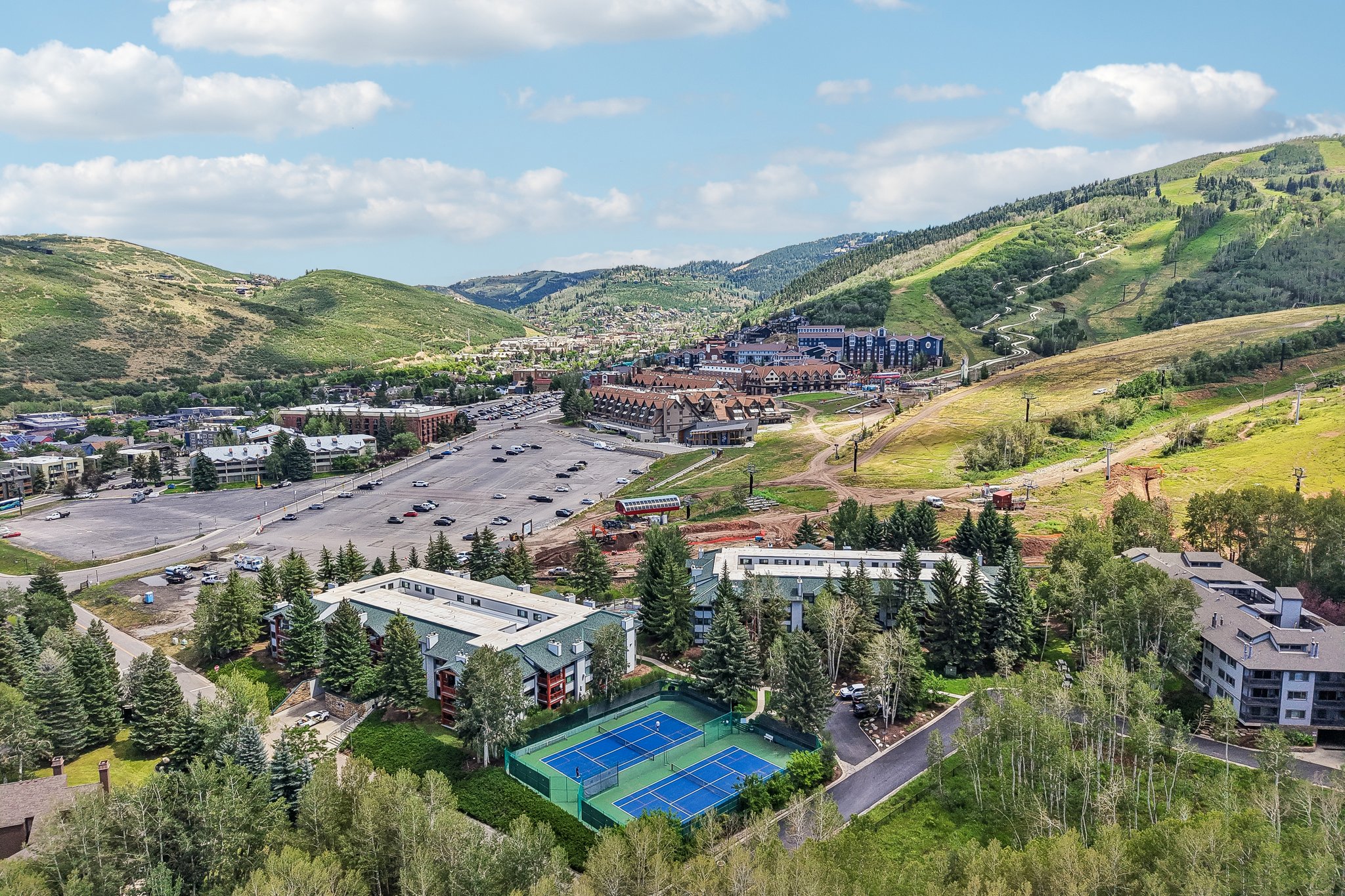 Mountain landscape with verdant hillsides and distant buildings