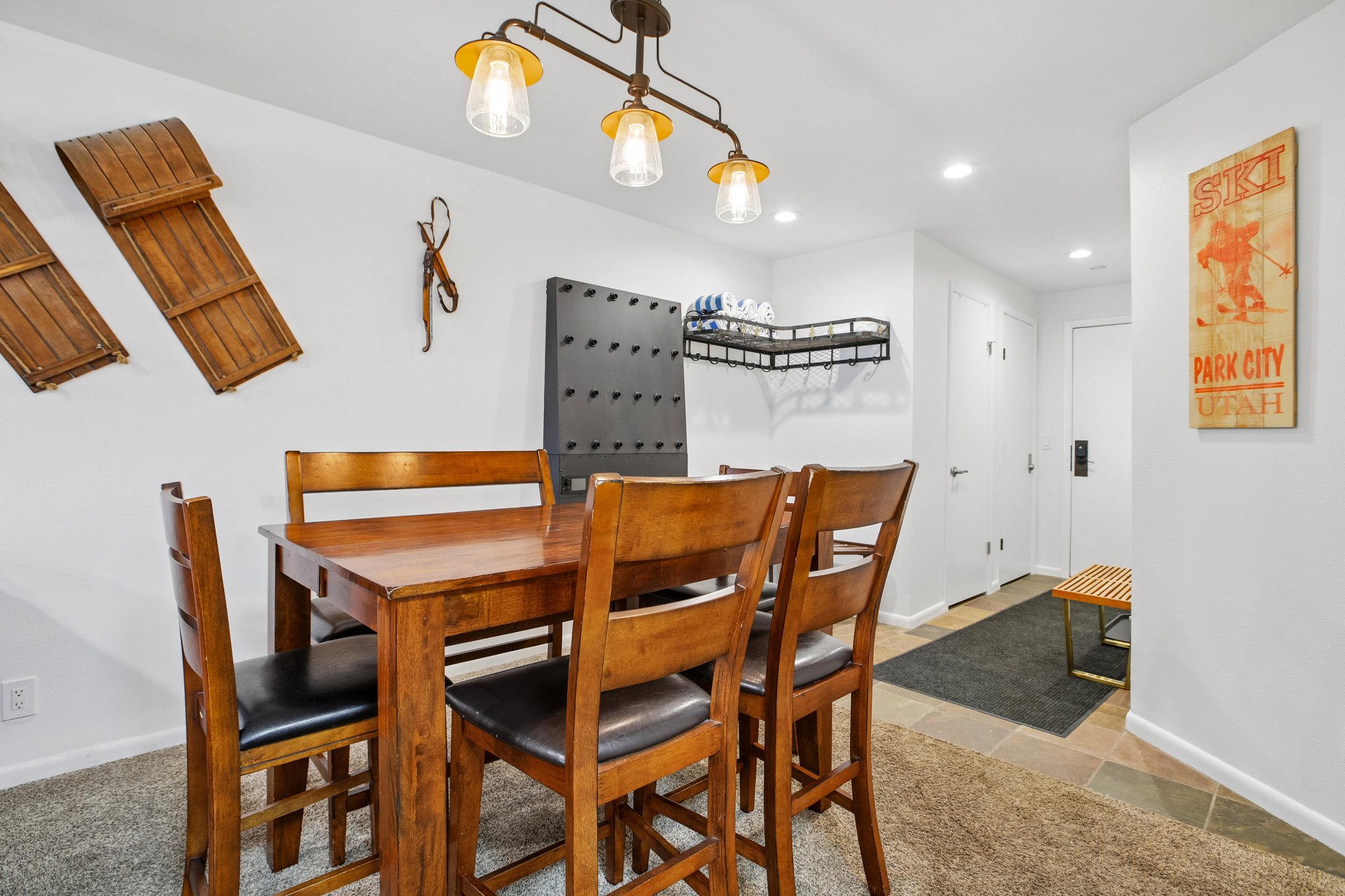 Dining area featuring a rectangular wood-finish table with seating for four