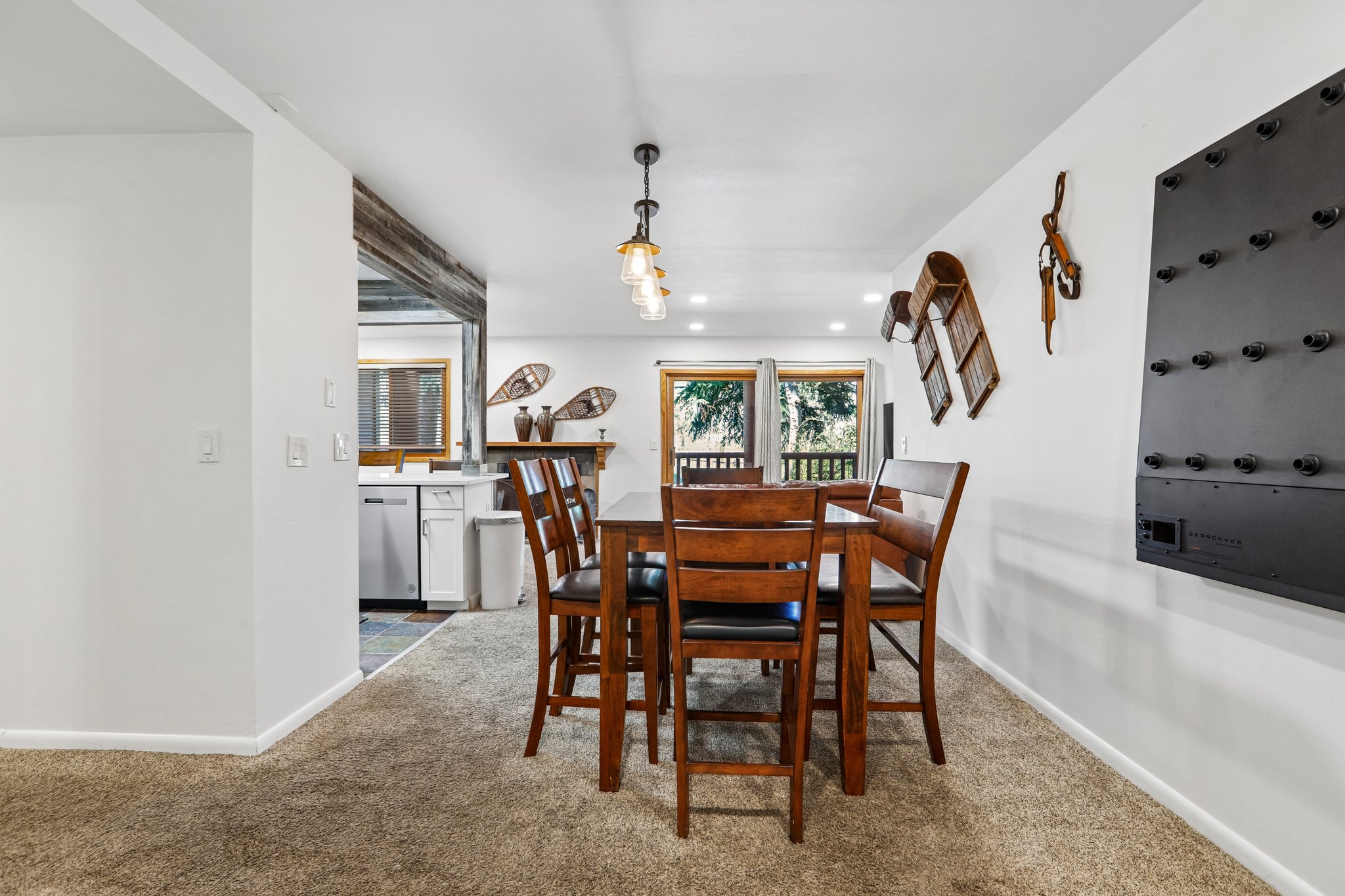 Dining area with carpet flooring and a multi-light pendant fixture