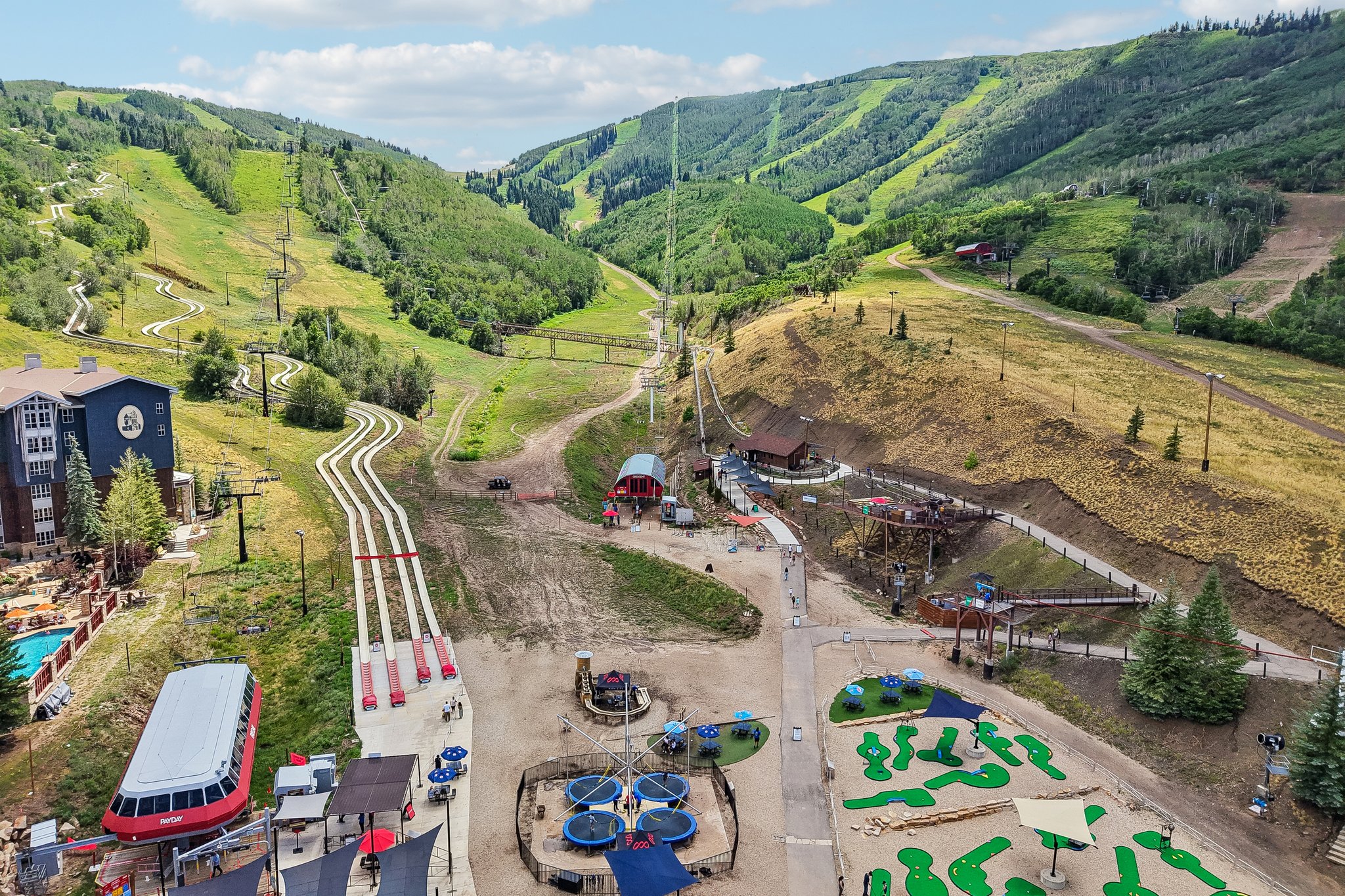 Mountain landscape featuring ski slopes and green hills