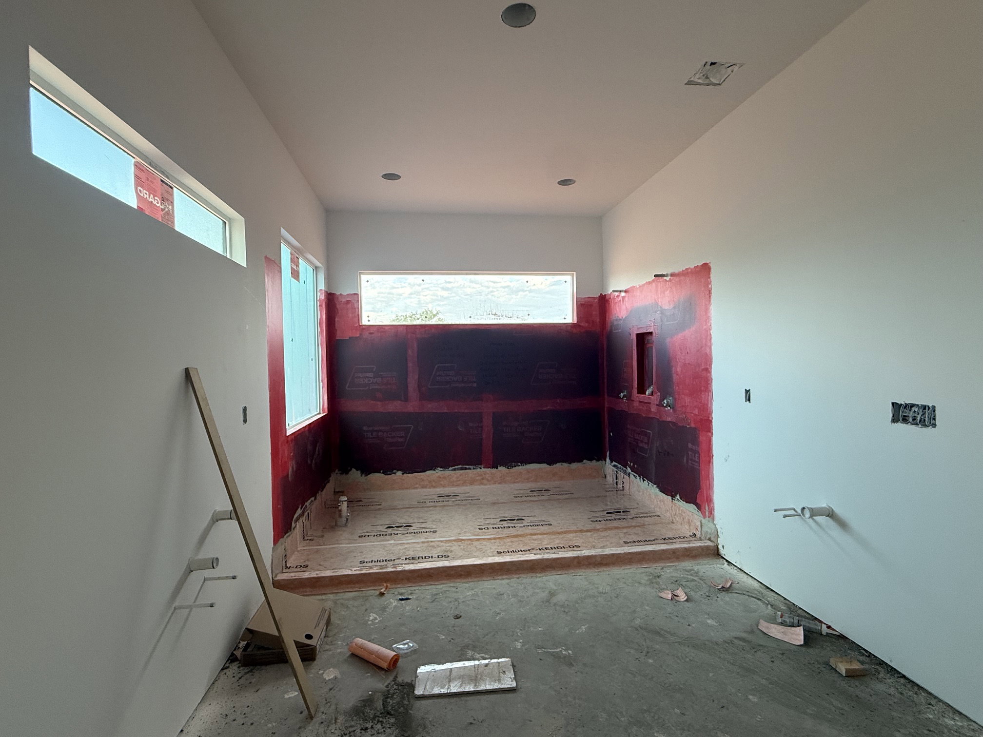 Spacious room featuring a walk-in shower with waterproof membrane installation