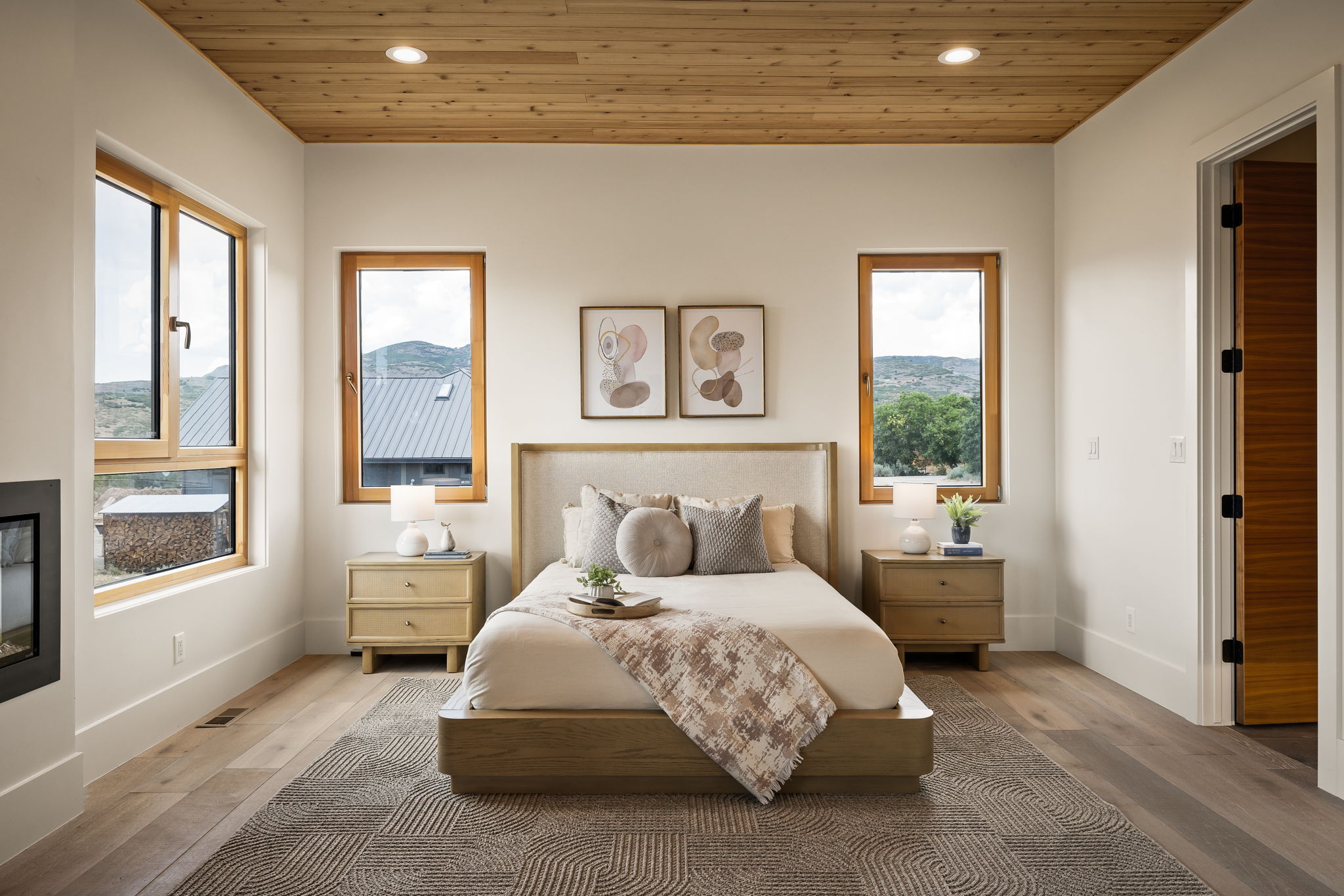 Recessed lighting illuminates a wood-paneled ceiling