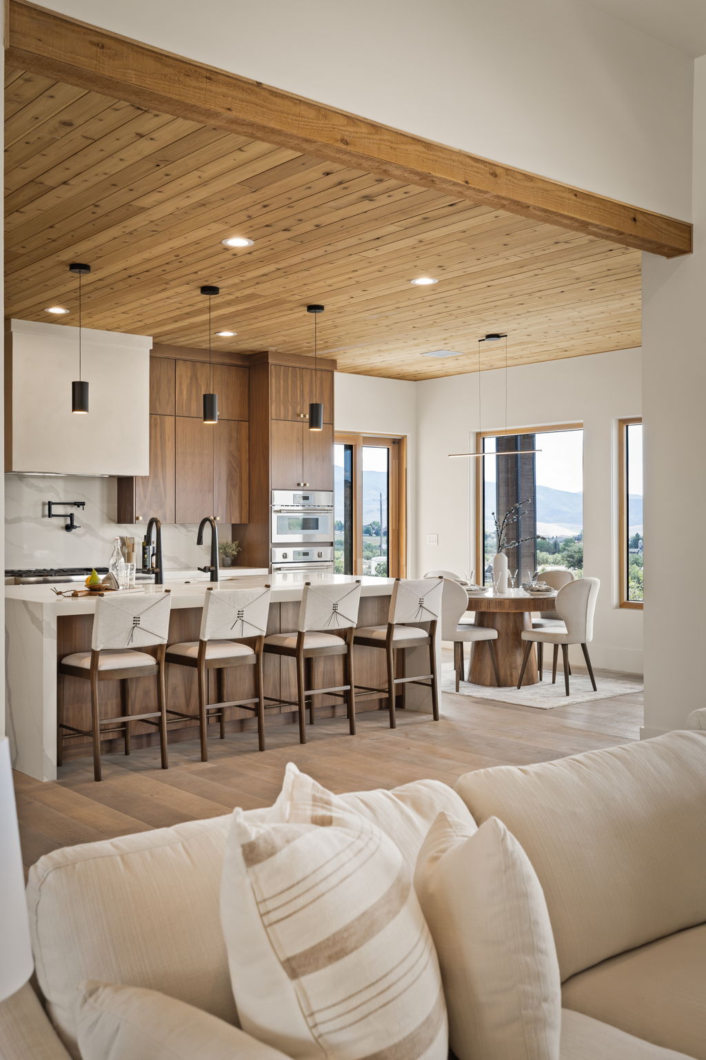 Kitchen featuring a wood-planked ceiling with exposed beam, recessed lighting, and a kitchen island with seating