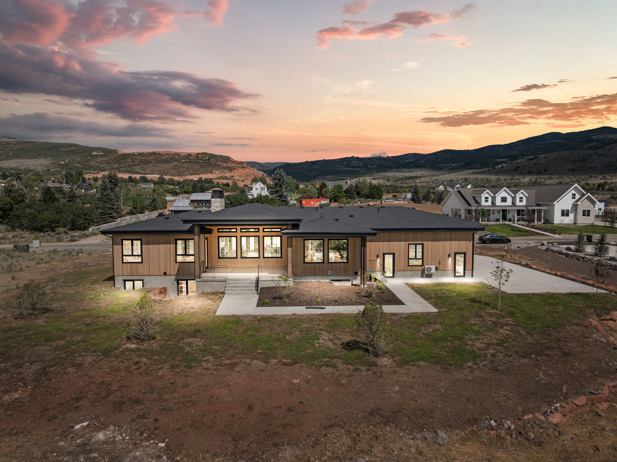 Contemporary residence featuring wood-tone siding and a dark roofline