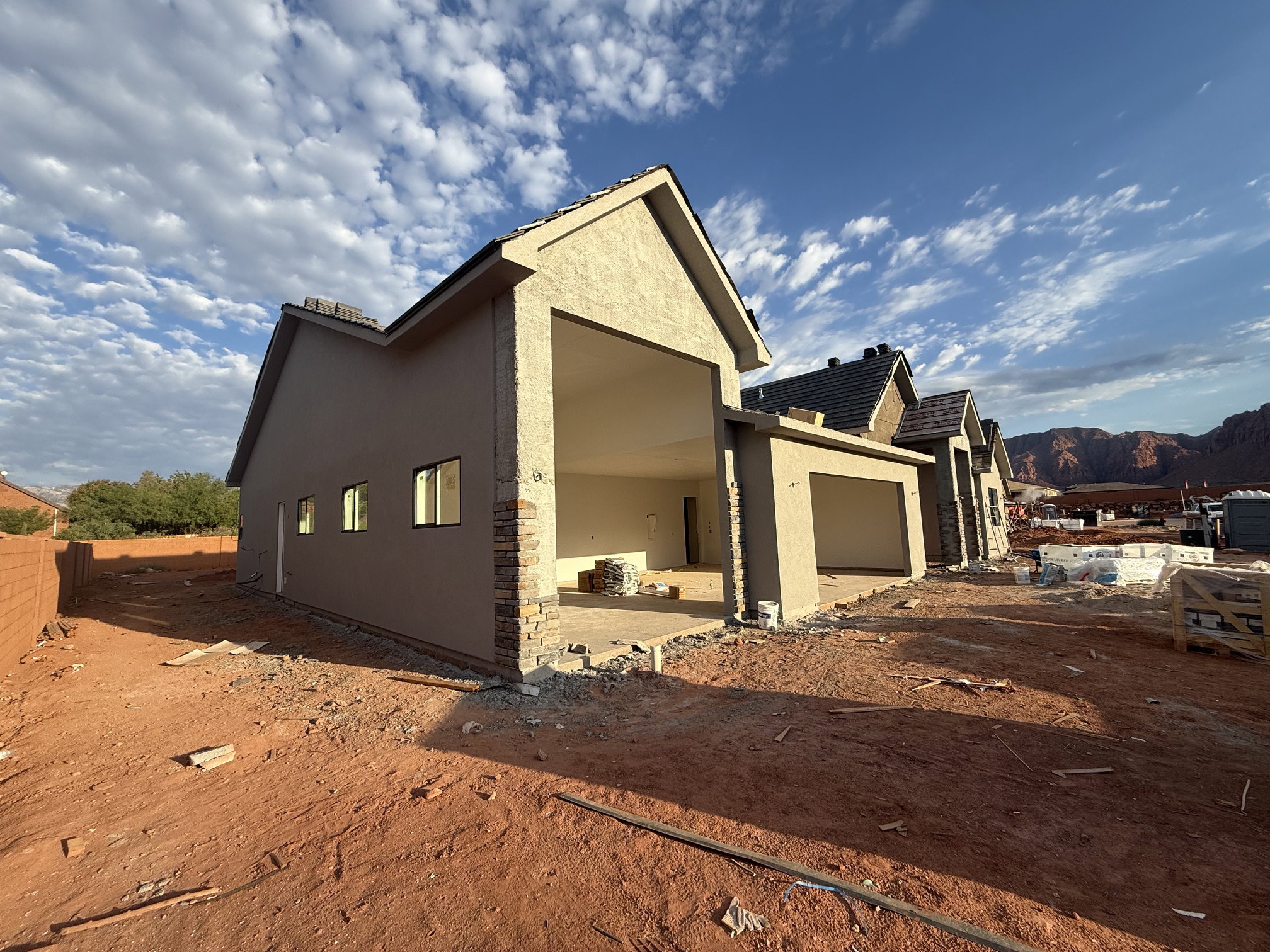 Newly constructed residence with stucco exterior and stone veneer accents