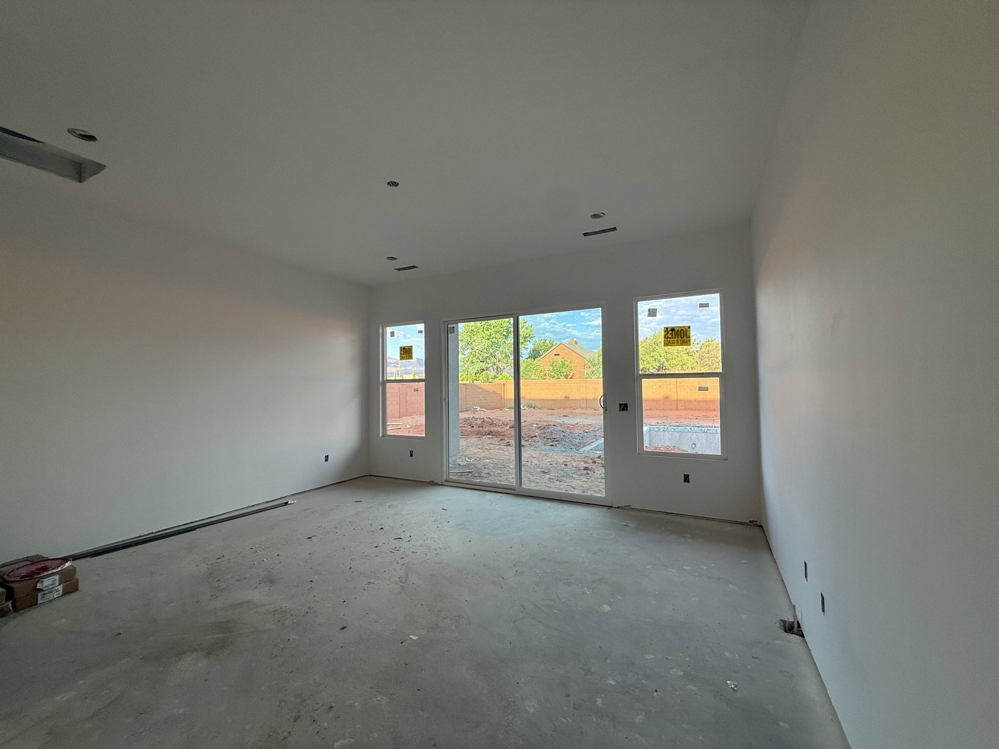 Spacious interior featuring a sliding glass door and two windows providing abundant natural light