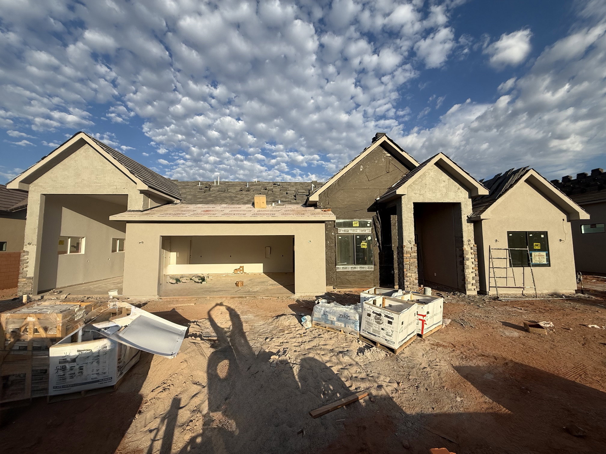 Contemporary multi-gabled exterior showcasing stucco siding, framed windows, and a two-car garage opening