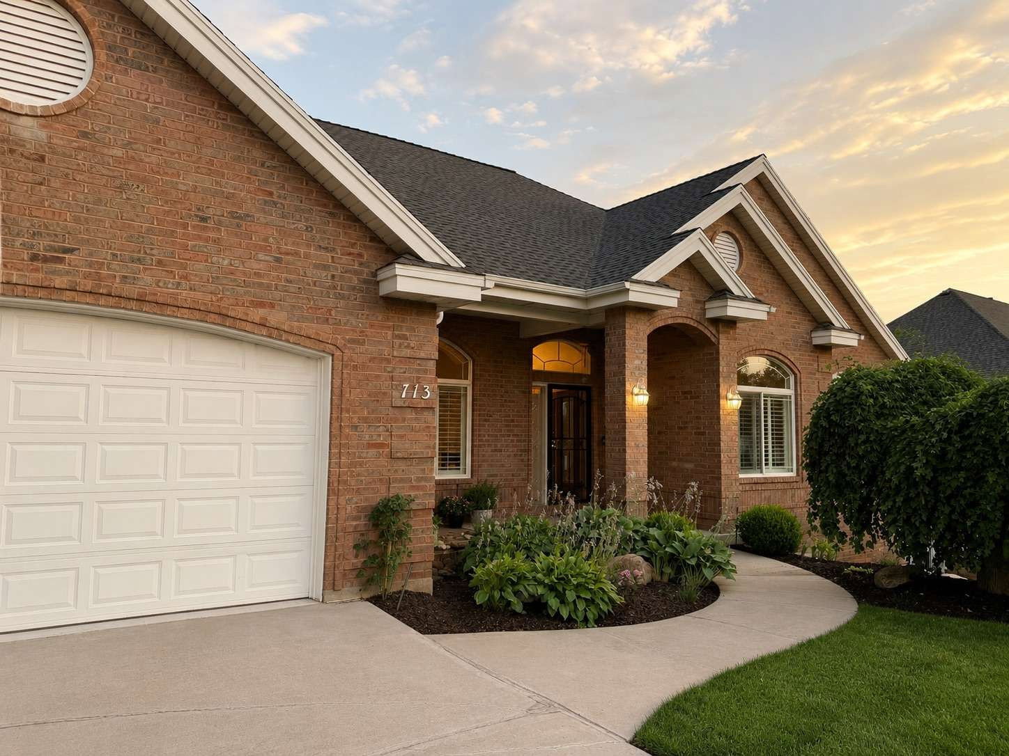 Brick exterior with a white panel garage door