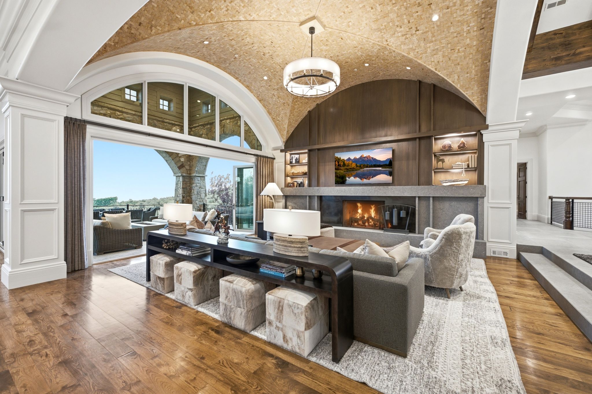 Vaulted arched ceiling with recessed lighting and exposed brickwork