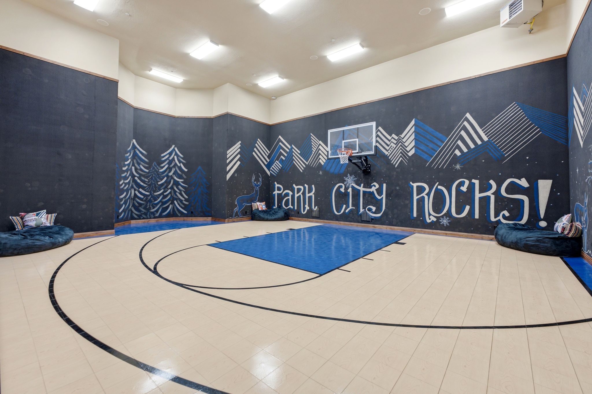 Indoor court featuring a regulation-height basketball hoop