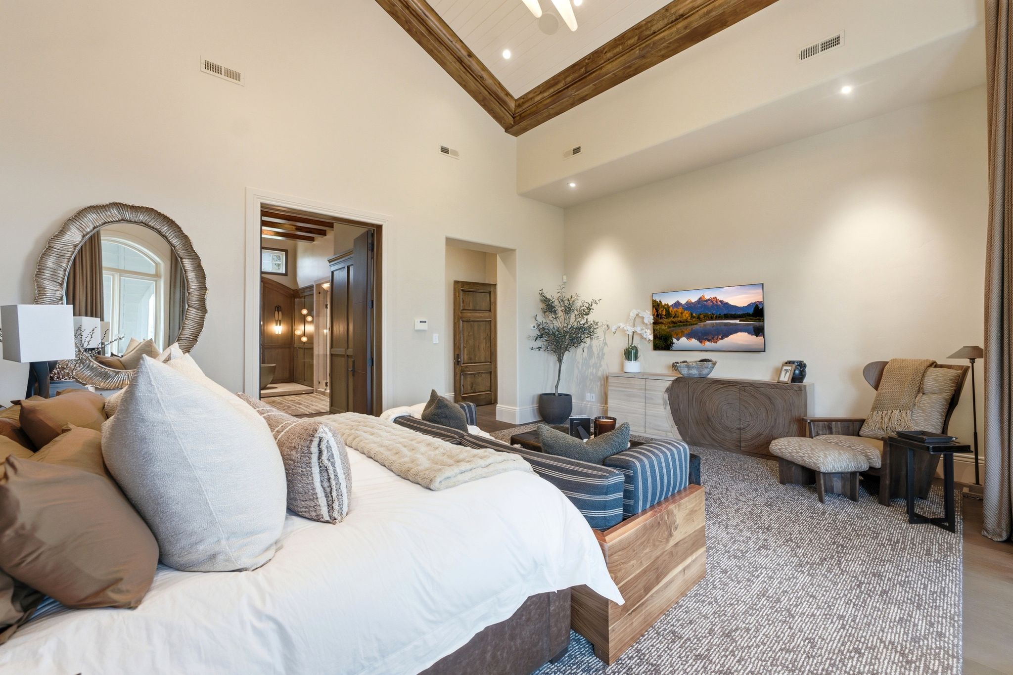 Room featuring a high vaulted ceiling with exposed wood beams and recessed lighting