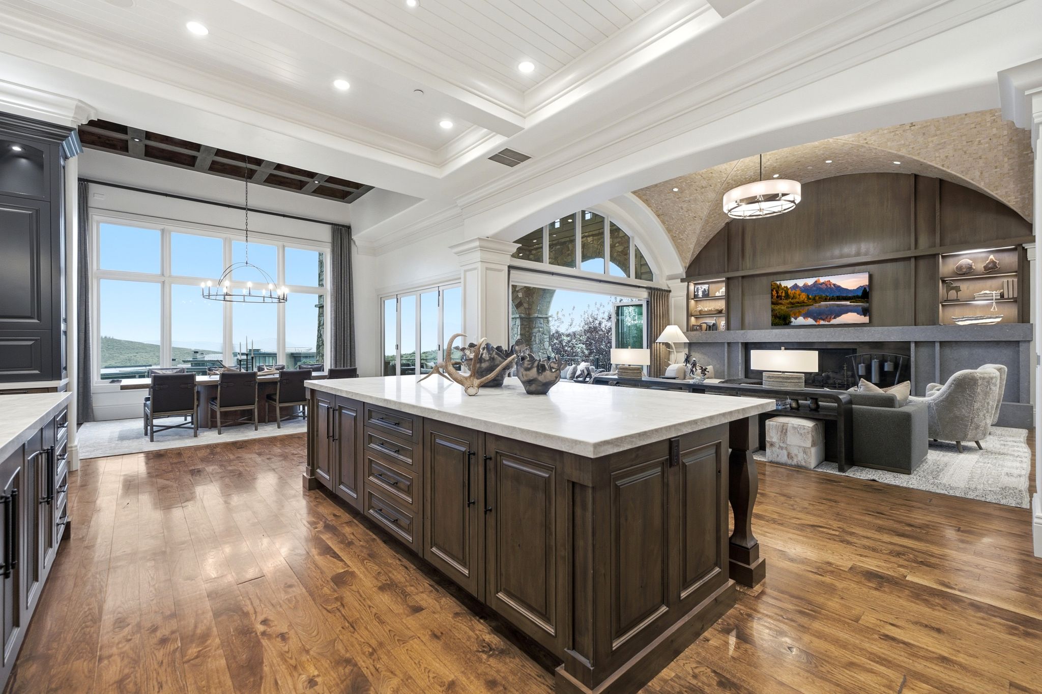 Spacious kitchen island featuring a light-toned countertop and rich wood-finish cabinetry