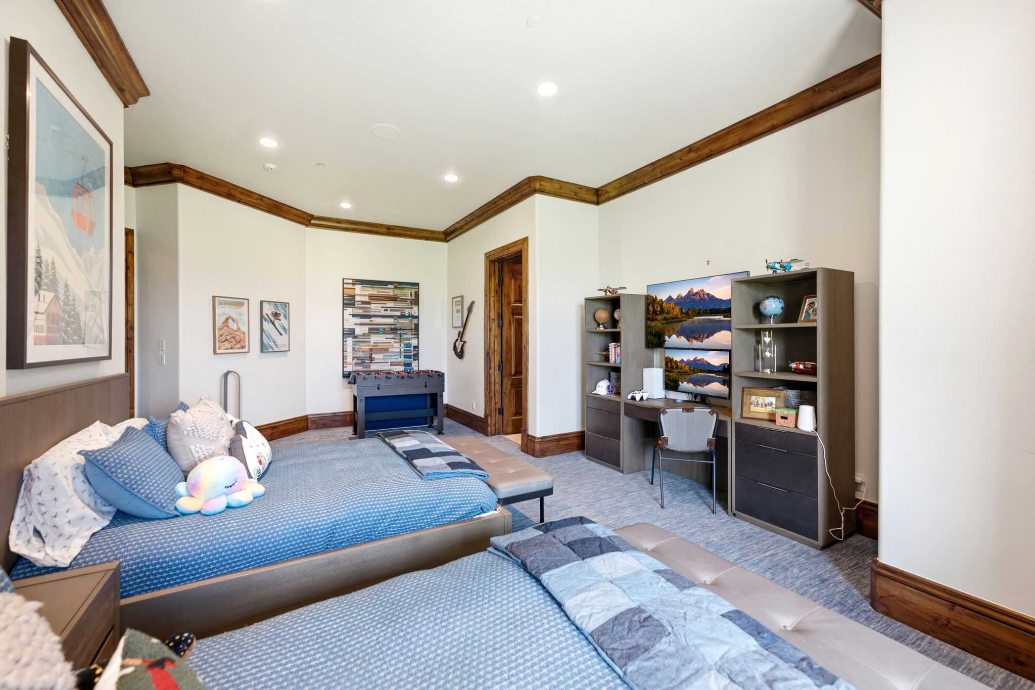 Recessed lighting illuminates the white walls and wood-finish crown molding