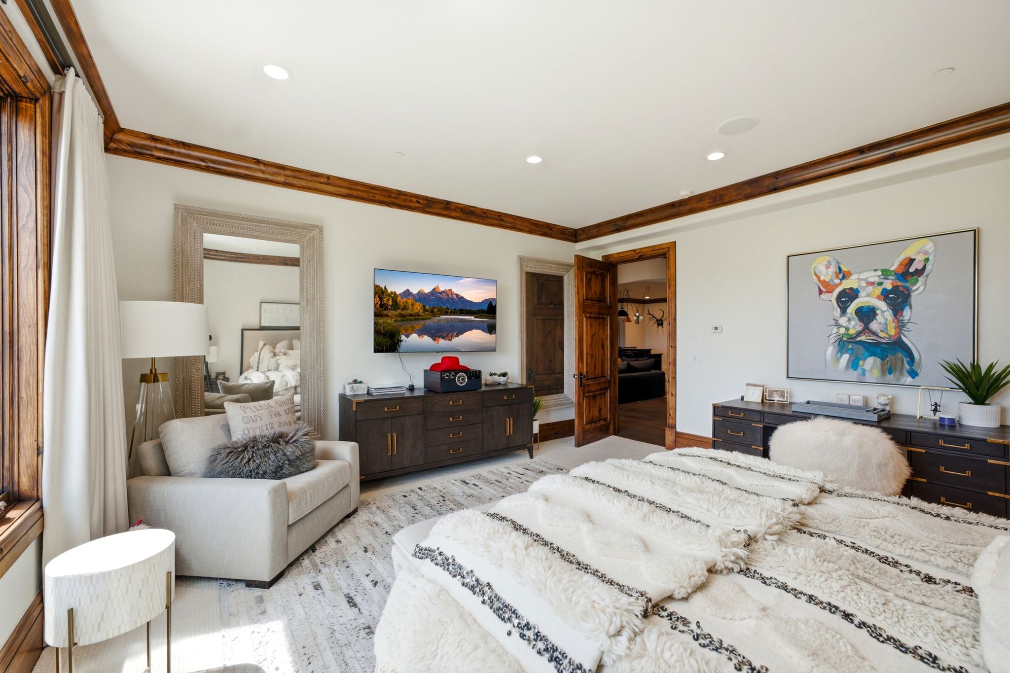 Spacious room featuring wood-finish flooring and white walls
