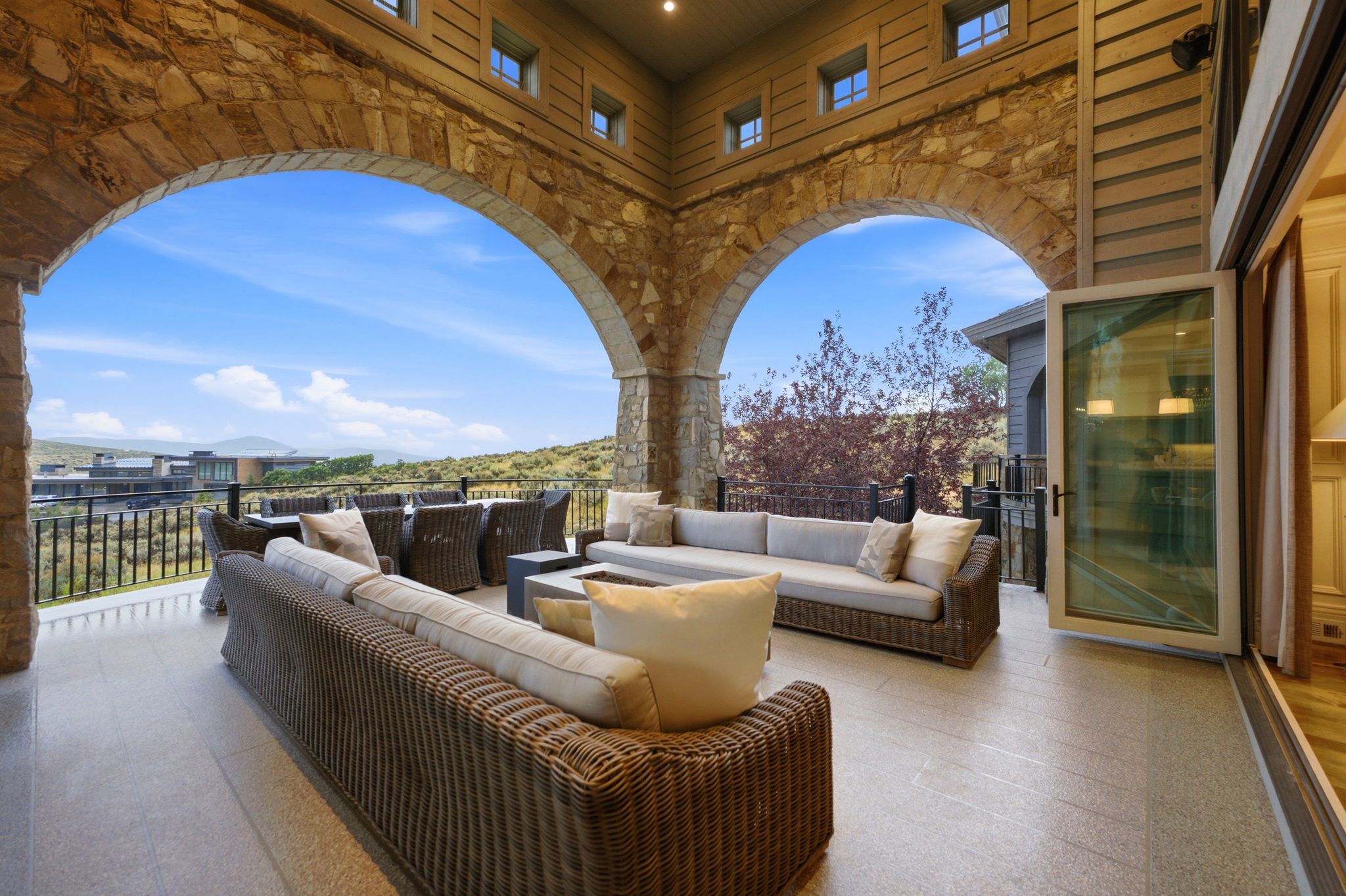 Expansive outdoor patio featuring stone archways and a tile floor