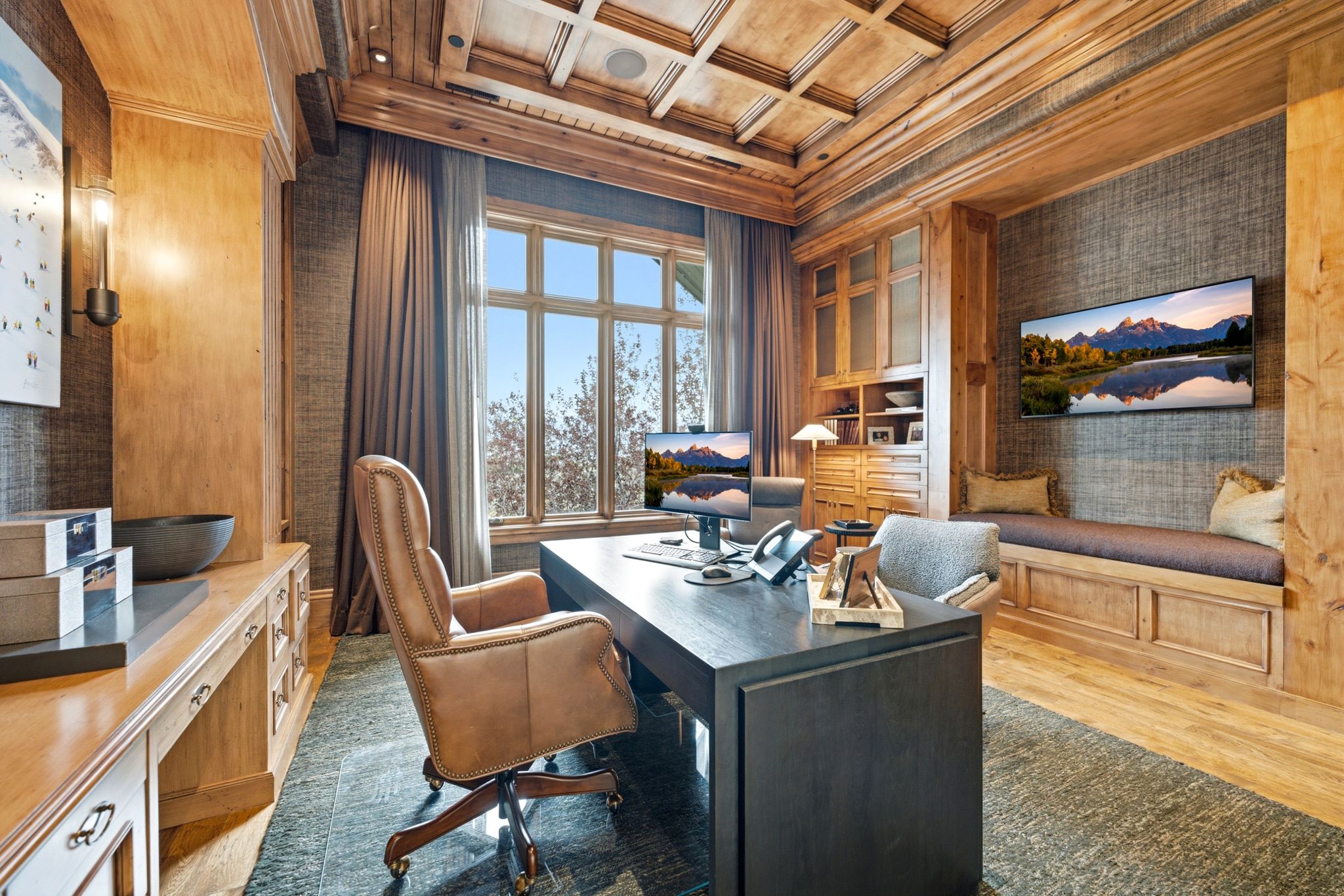 Office space featuring a coffered wood ceiling, built-in cabinetry, and a window seat with integrated storage