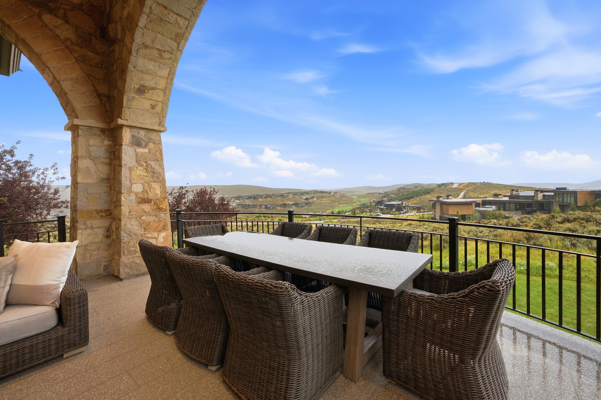 Expansive outdoor patio featuring stone archways and columns