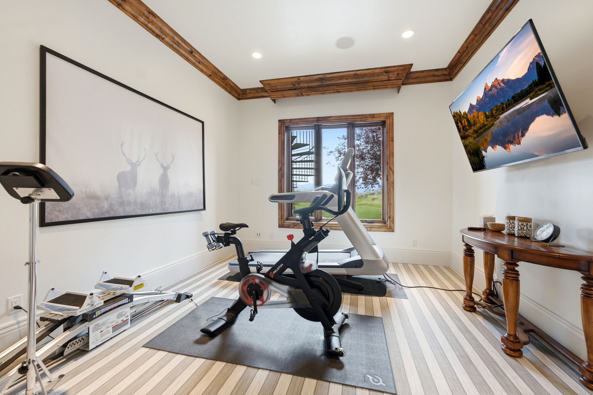 Dedicated exercise space featuring light-toned striped flooring and wood-finish trim
