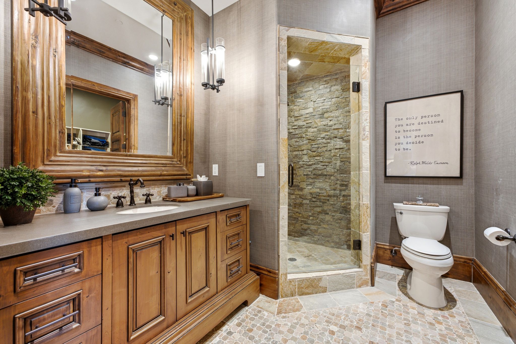 Wood-finish vanity with a stone countertop and an undermount sink