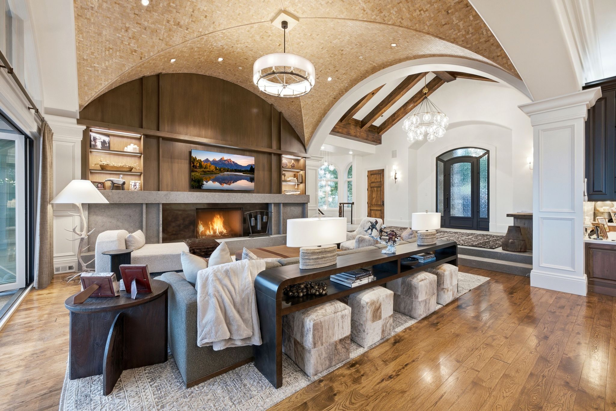 Vaulted brick-finish ceiling featuring recessed lighting and a contemporary chandelier
