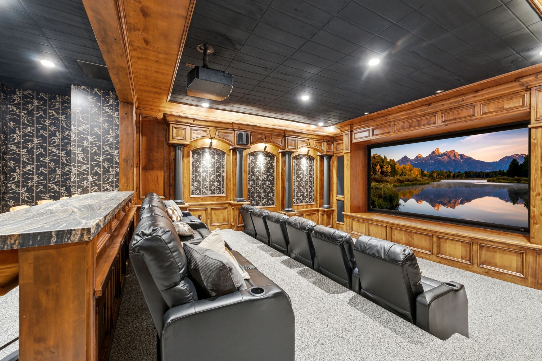 Dedicated home theater featuring a large screen display and projector