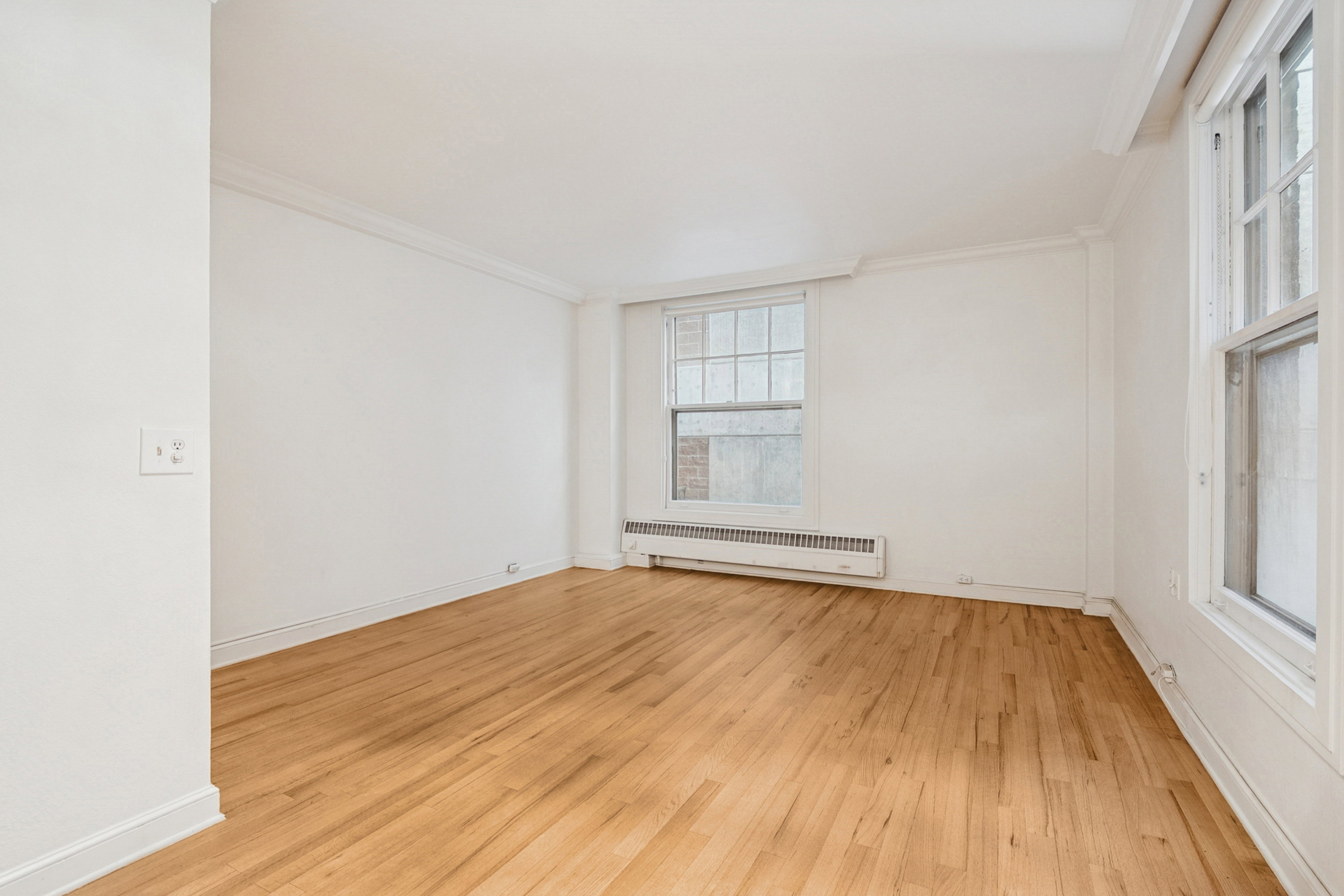 Light hardwood flooring, white walls