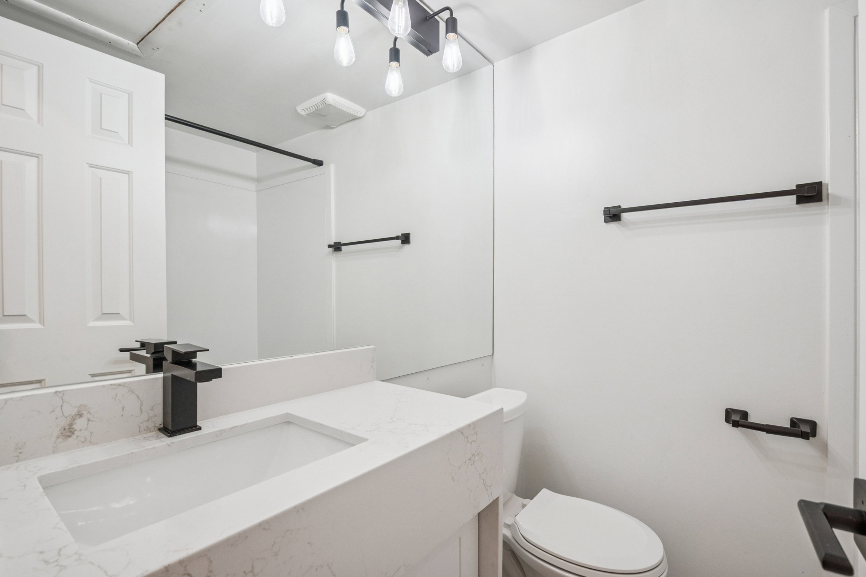 Bathroom 1 featuring a contemporary vanity with an integrated rectangular sink and a quartz-finish countertop