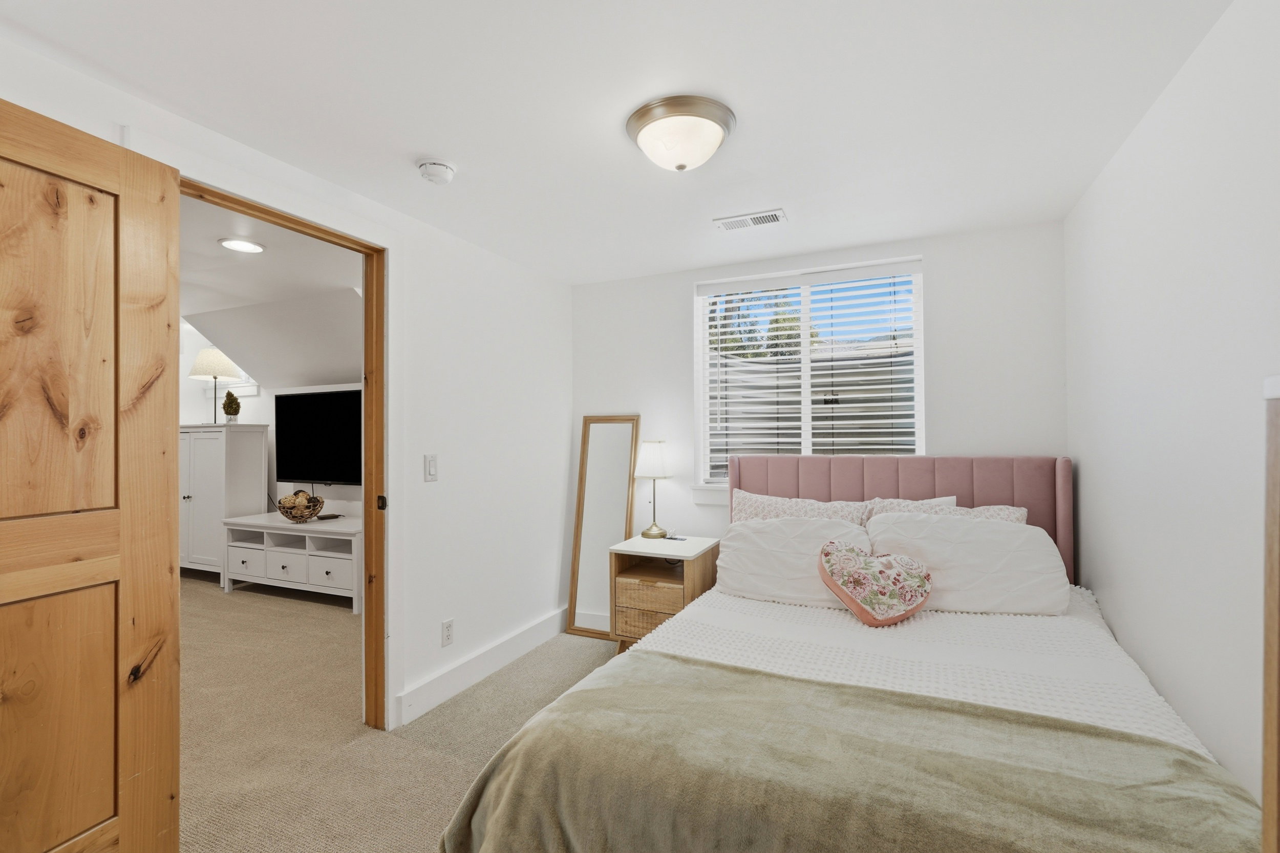 White painted walls with a window featuring horizontal blinds