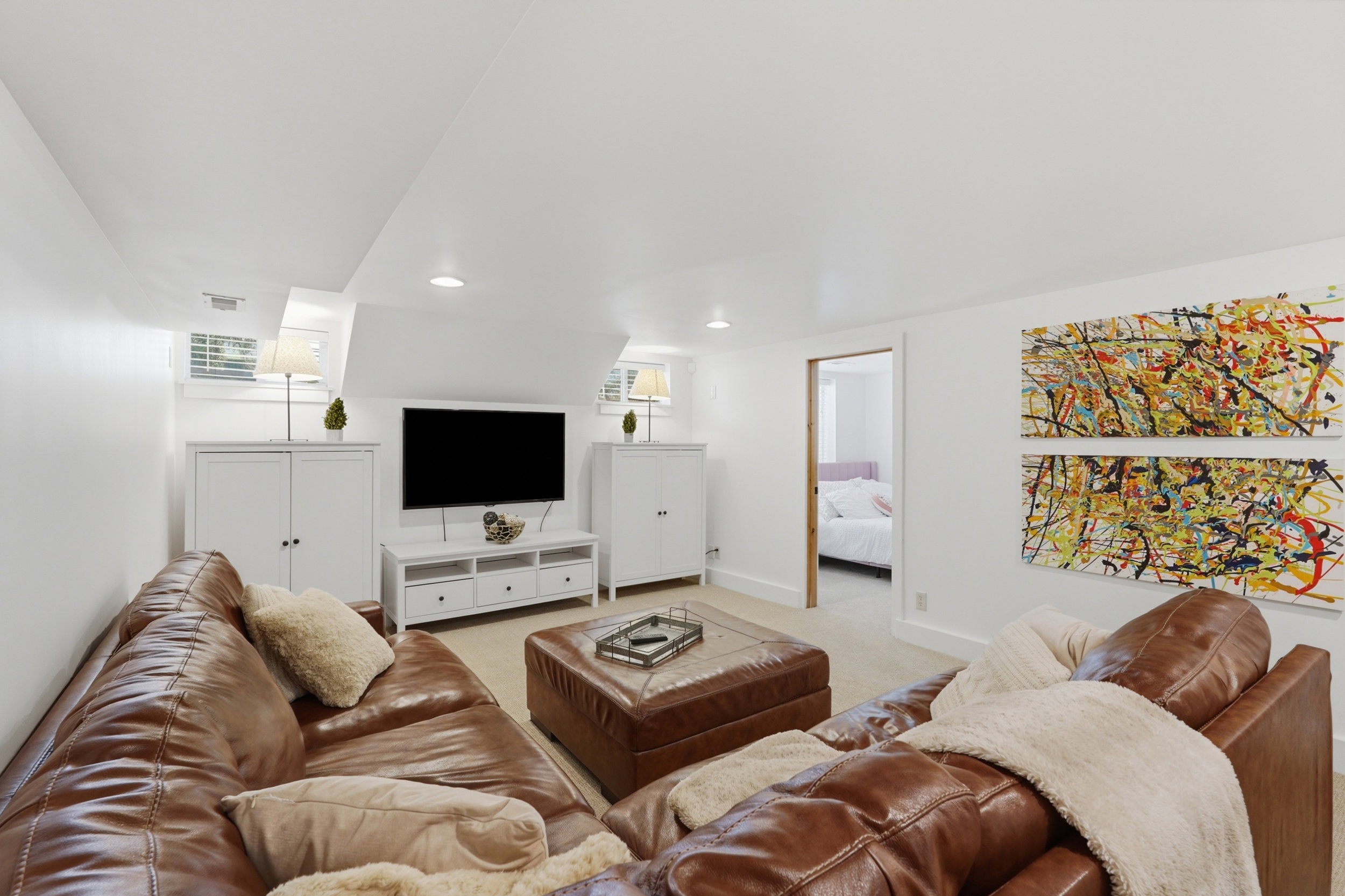 Spacious lower level featuring recessed lighting, light-toned carpeting, and a built-in media console