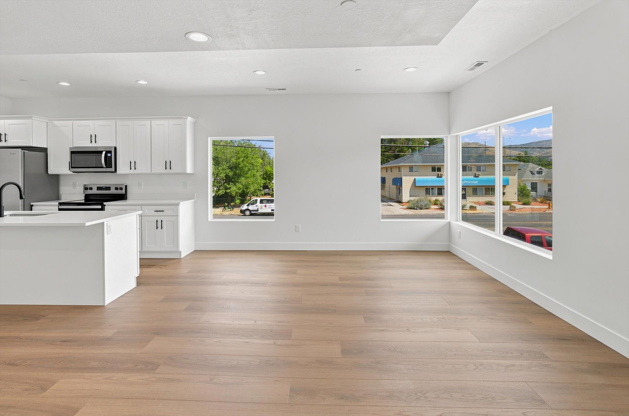 Open-concept living area with wood-finish flooring