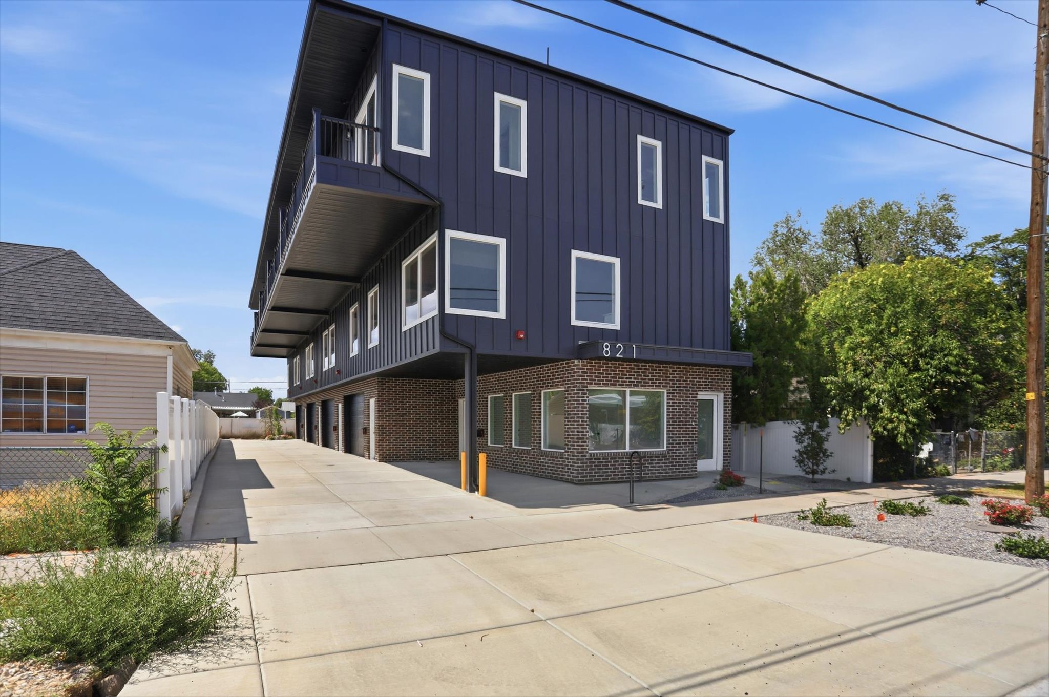 Modern multi-level structure featuring a dark facade with white-framed windows
