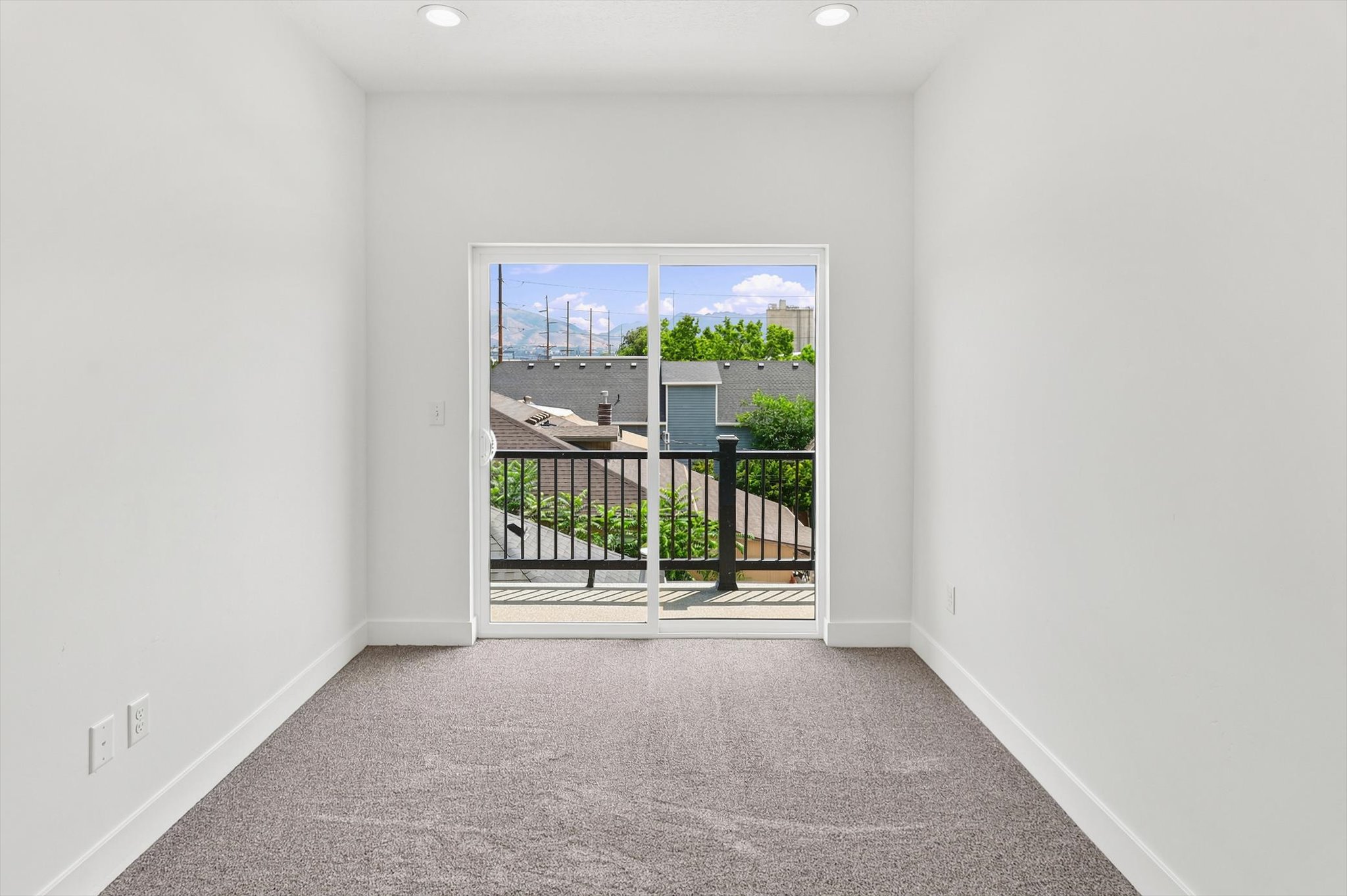 Interior space featuring plush grey carpeting and white painted walls