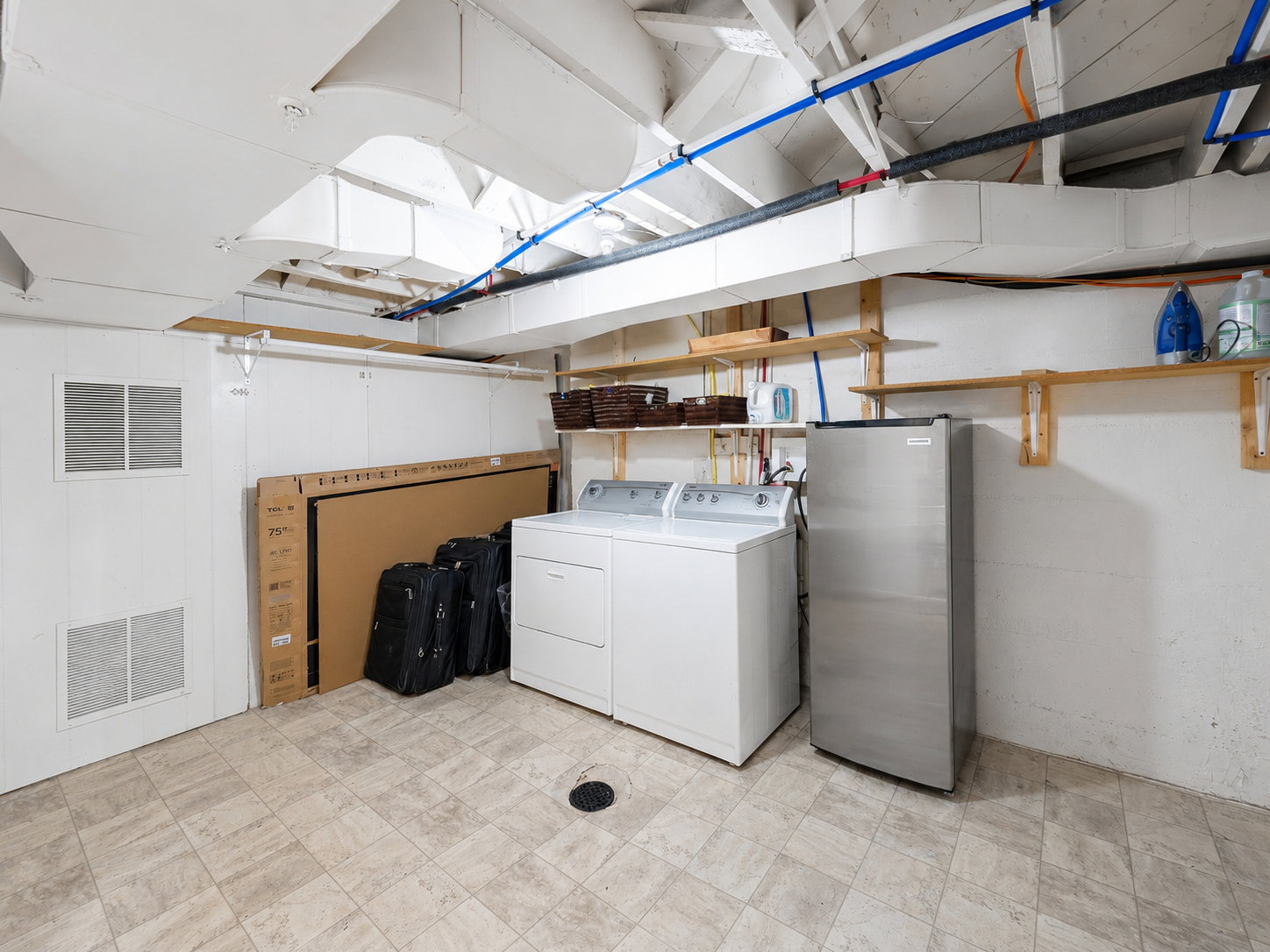 Laundry area featuring a top-loading washer and front-loading dryer