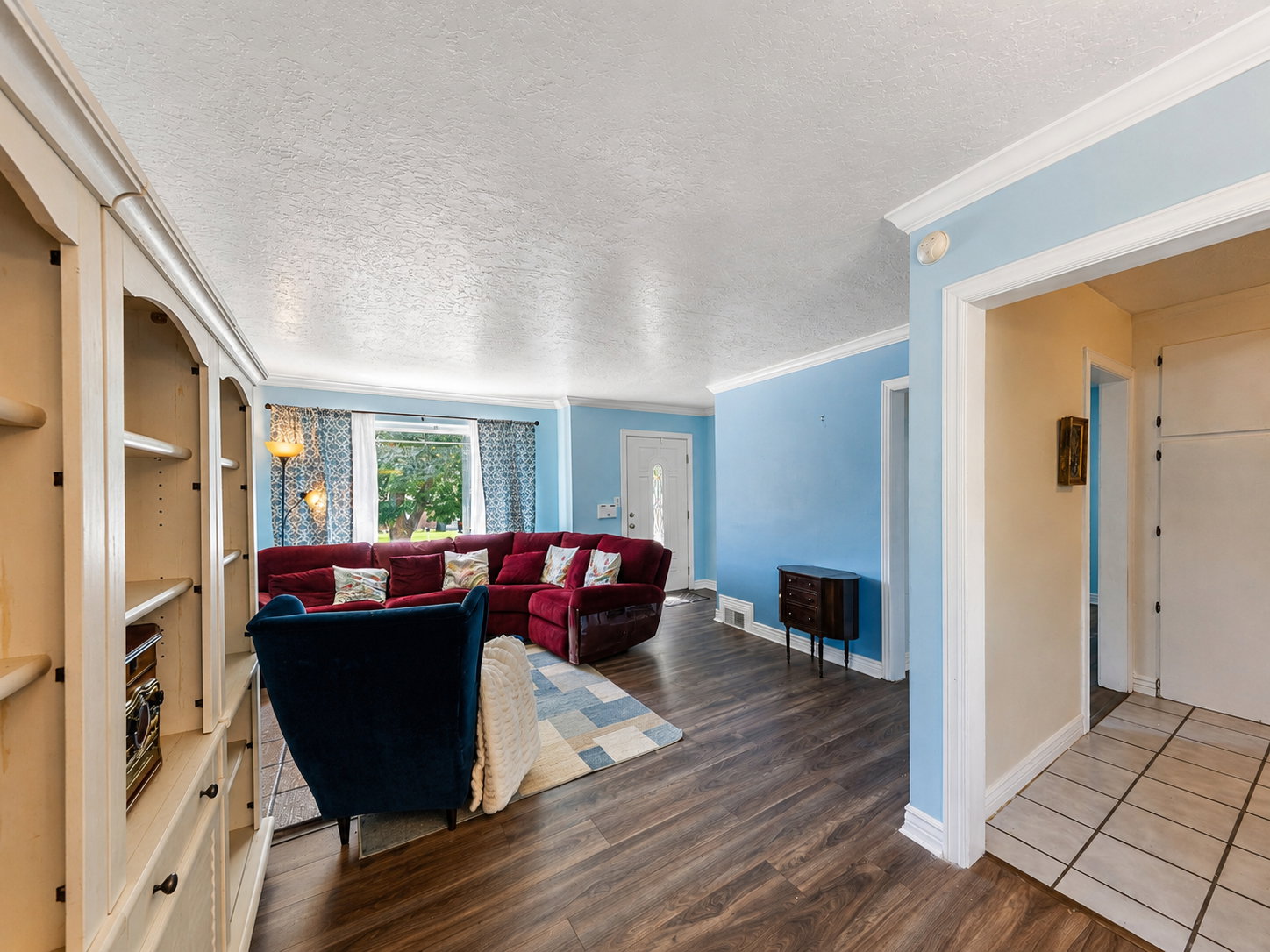 Living space featuring wood-finish flooring and light blue walls
