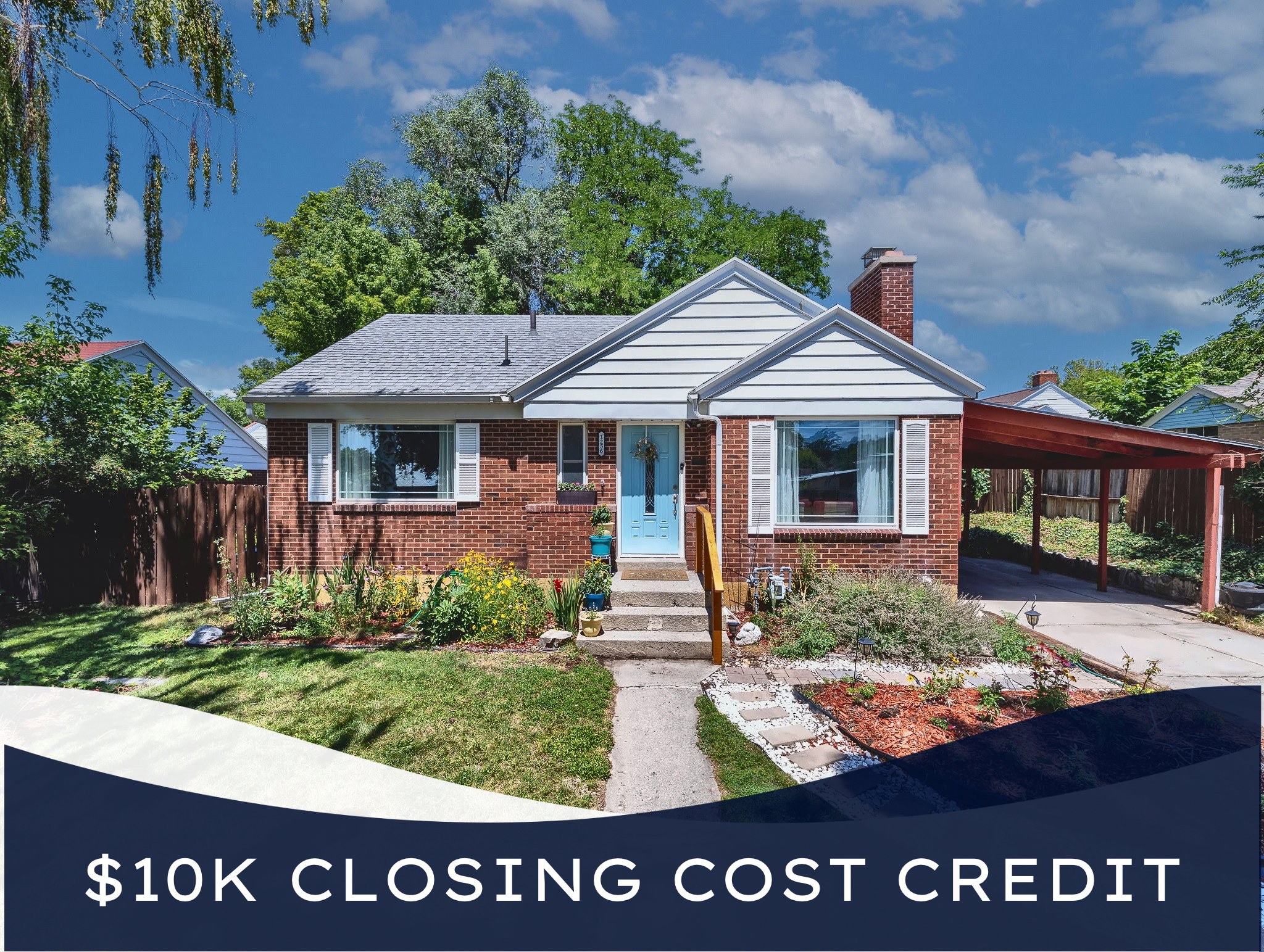 Brick facade residence featuring white vinyl siding gables, an attached carport, a light blue entry door, and established landscaping